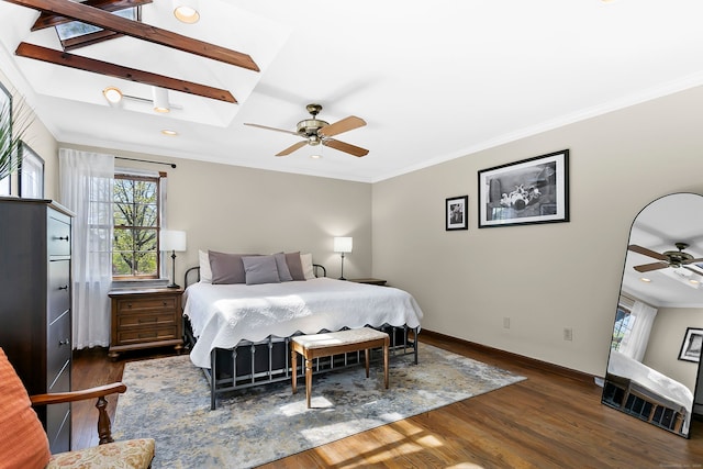 bedroom with baseboards, dark wood finished floors, crown molding, and multiple windows