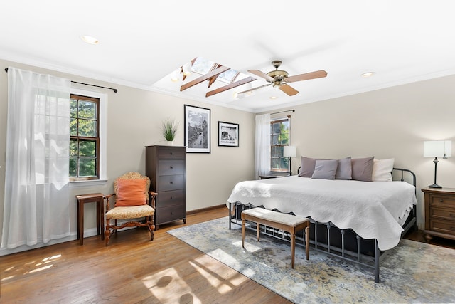 bedroom with multiple windows and wood finished floors