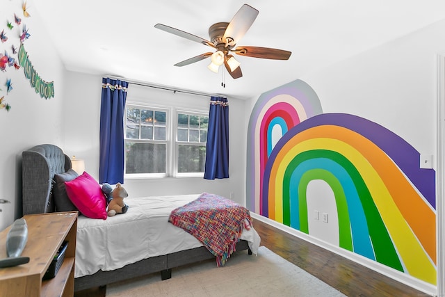 bedroom featuring baseboards, a ceiling fan, and wood finished floors
