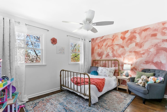 bedroom with baseboards, ceiling fan, and wood finished floors