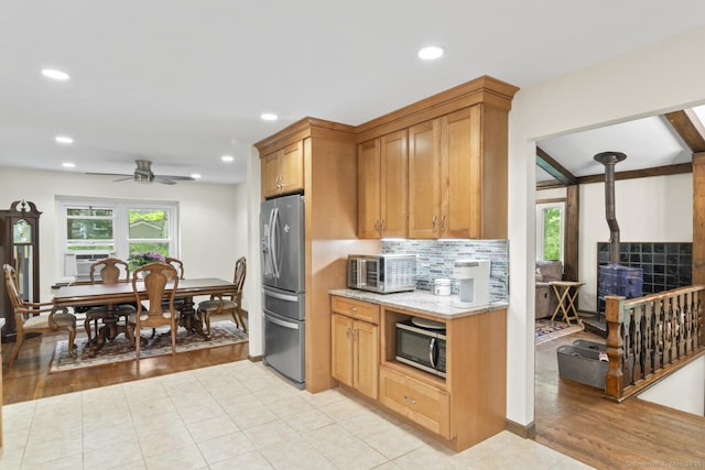 49 Birch Hill Rd, Newtown, CT 06470 - kitchen with appliances with stainless steel finishes, light stone countertops, backsplash, a ceiling fan, and recessed lighting