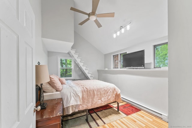 49 Birch Hill Rd, Newtown, CT 06470 - bedroom with baseboard heating, multiple windows, vaulted ceiling, and wood finished floors