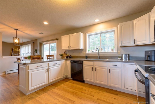kitchen featuring a baseboard heating unit, a sink, black appliances, a peninsula, and a textured ceiling