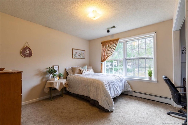 bedroom with visible vents, a baseboard heating unit, a textured ceiling, and carpet