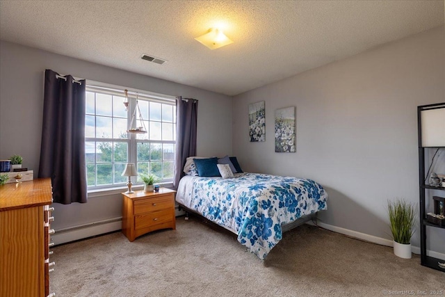carpeted bedroom featuring a textured ceiling, visible vents, baseboard heating, and baseboards