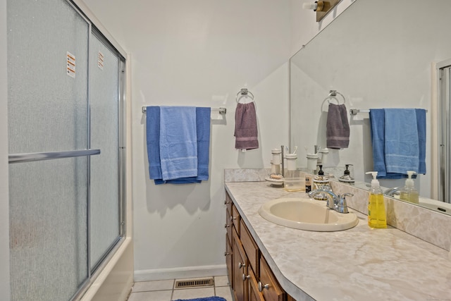 full bathroom with tile patterned flooring, vanity, enclosed tub / shower combo, baseboards, and visible vents