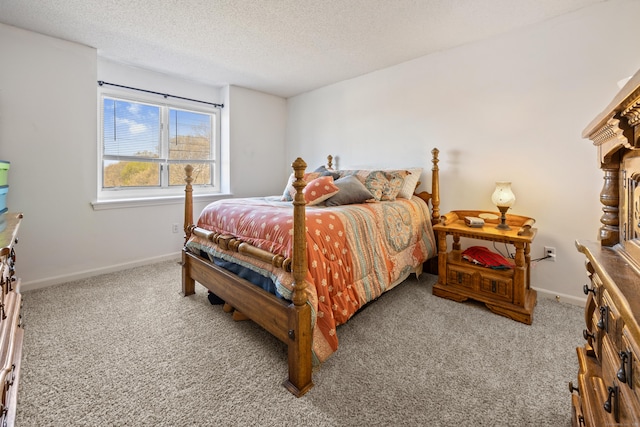 bedroom with carpet floors, a textured ceiling, and baseboards