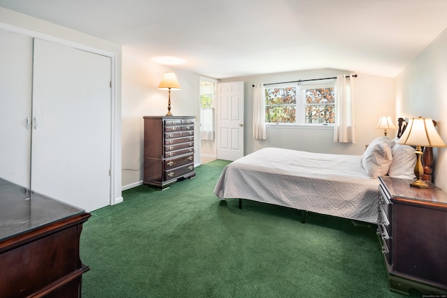 carpeted bedroom featuring baseboards and vaulted ceiling