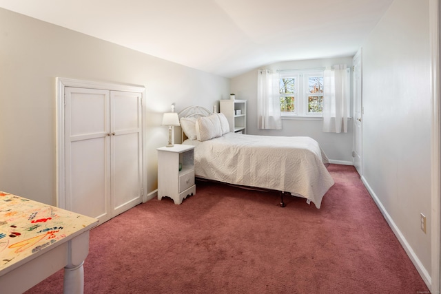 bedroom with baseboards, carpet flooring, and lofted ceiling