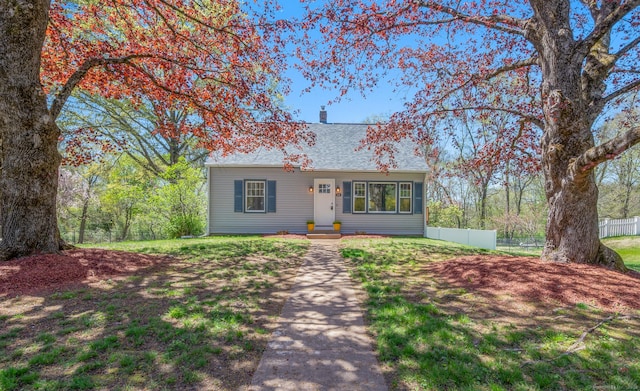64 Prospect St, Colchester, CT 06415 - view of front of home featuring a shingled roof, fence, and a chimney