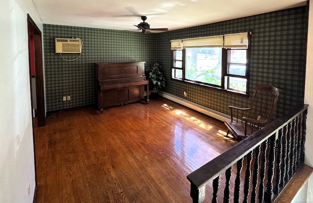 653 Andrew Mountain Rd, Naugatuck, CT 06770 - empty room with an AC wall unit, a ceiling fan, wallpapered walls, and wood finished floors
