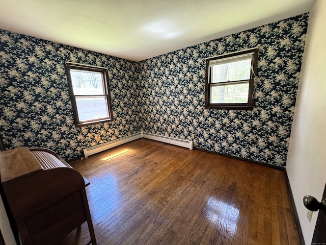 653 Andrew Mountain Rd, Naugatuck, CT 06770 - empty room with baseboards, baseboard heating, wallpapered walls, and wood-type flooring