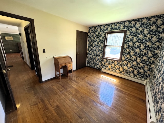 653 Andrew Mountain Rd, Naugatuck, CT 06770 - unfurnished bedroom with baseboards, wallpapered walls, a baseboard heating unit, and dark wood-style flooring