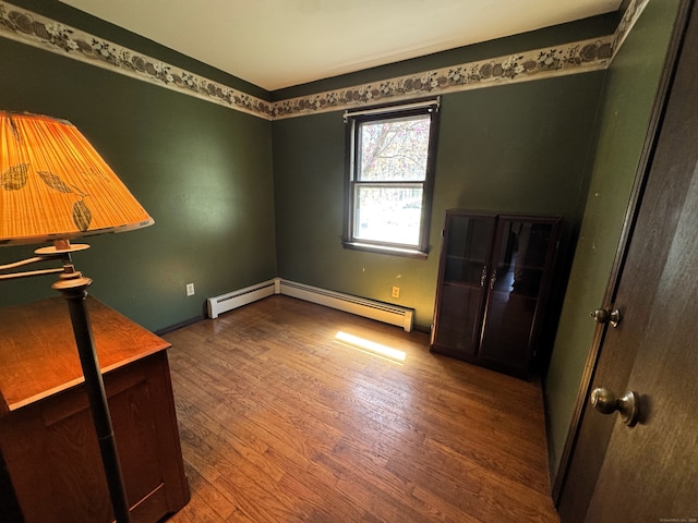 653 Andrew Mountain Rd, Naugatuck, CT 06770 - empty room with wood finished floors, baseboard heating, and baseboards
