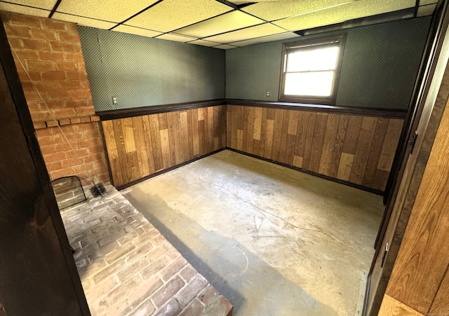653 Andrew Mountain Rd, Naugatuck, CT 06770 - basement with wood walls, a paneled ceiling, and a wainscoted wall