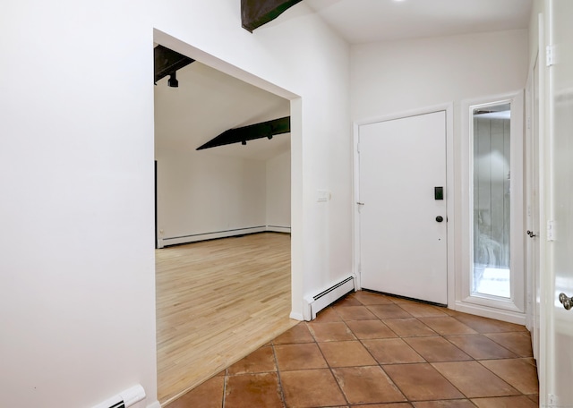 foyer featuring tile patterned floors, baseboard heating, beam ceiling, and a baseboard radiator