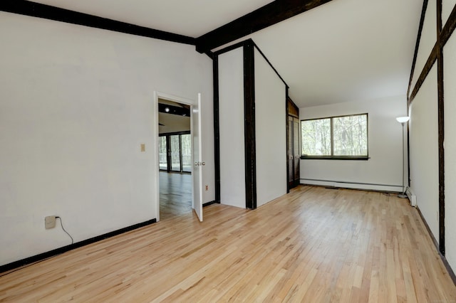 spare room with baseboards, vaulted ceiling with beams, a baseboard heating unit, and hardwood / wood-style flooring