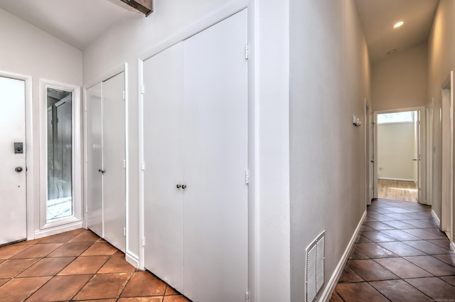 hallway with baseboards, tile patterned flooring, recessed lighting, and visible vents