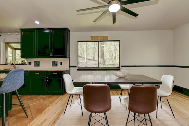 dining space featuring ceiling fan and light wood-type flooring