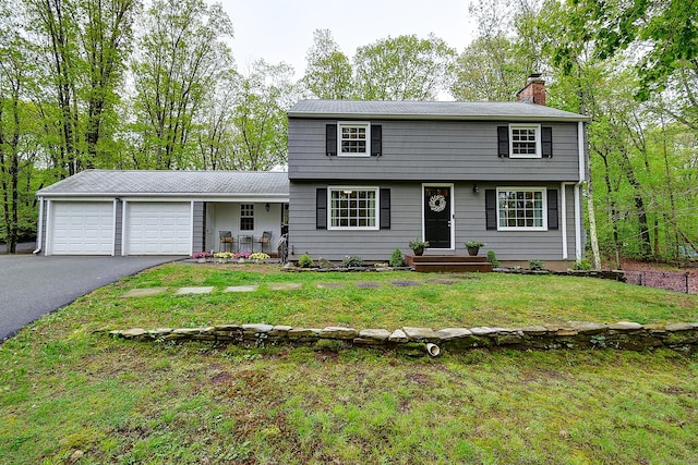 267 Foote Rd, Glastonbury, CT 06073 - colonial inspired home featuring a chimney, an attached garage, asphalt driveway, and a front yard