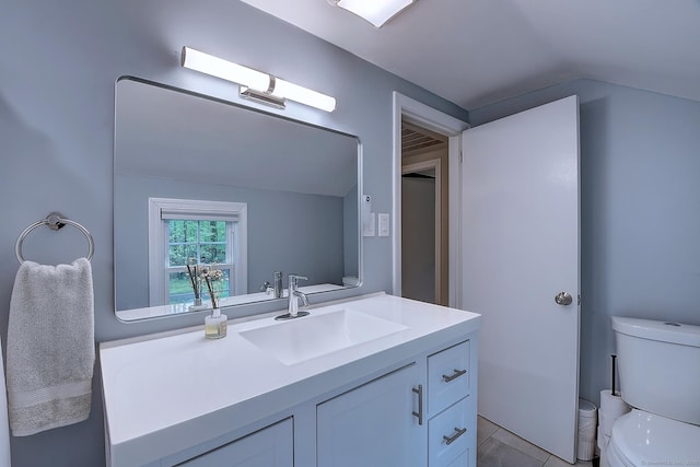 267 Foote Rd, Glastonbury, CT 06073 - bathroom featuring lofted ceiling, toilet, vanity, and tile patterned flooring