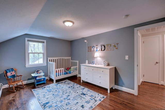 267 Foote Rd, Glastonbury, CT 06073 - bedroom with dark wood-style floors, baseboards, vaulted ceiling, and a crib
