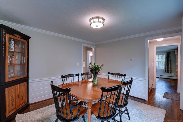 267 Foote Rd, Glastonbury, CT 06073 - dining space with baseboard heating, wood finished floors, crown molding, and baseboards