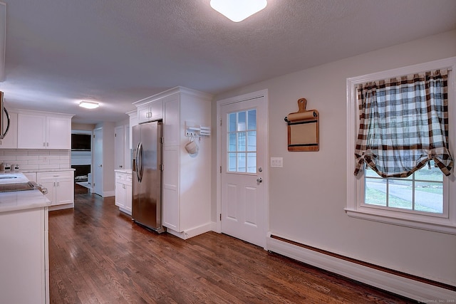 267 Foote Rd, Glastonbury, CT 06073 - foyer entrance featuring baseboard heating, dark wood-style floors, and baseboards