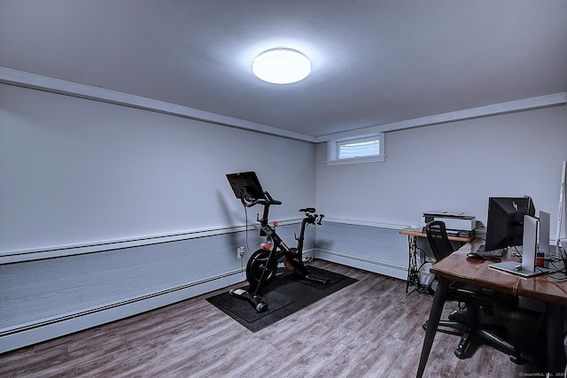 267 Foote Rd, Glastonbury, CT 06073 - exercise area with wood finished floors, a baseboard heating unit, and a wainscoted wall