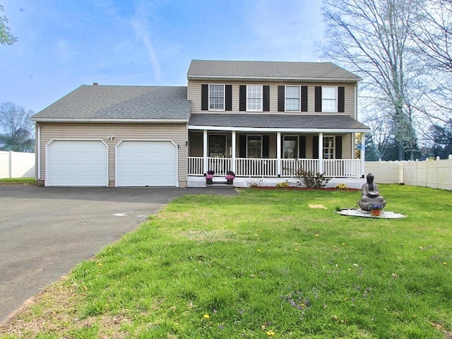 view of front facade with a front lawn, a garage, covered porch, driveway, and fence