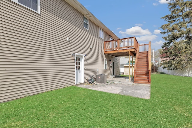 back of house featuring stairs, a patio, a wooden deck, a lawn, and central AC unit