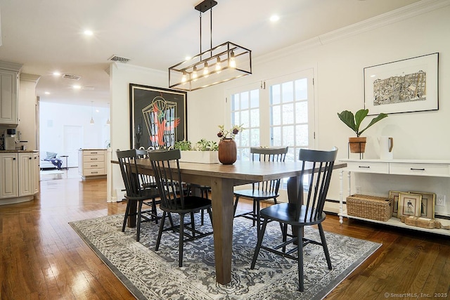 dining room with ornamental molding, dark wood-type flooring, and visible vents