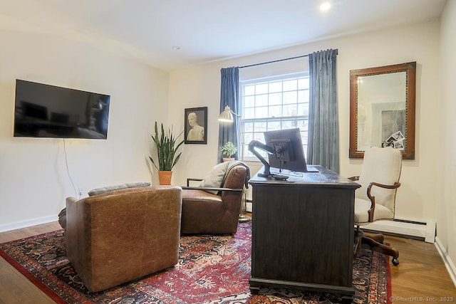 interior space with baseboards, wood finished floors, and baseboard heating