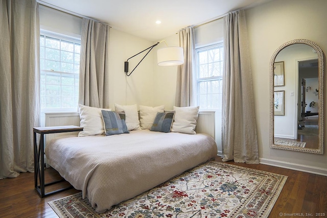 bedroom featuring baseboards and dark wood finished floors