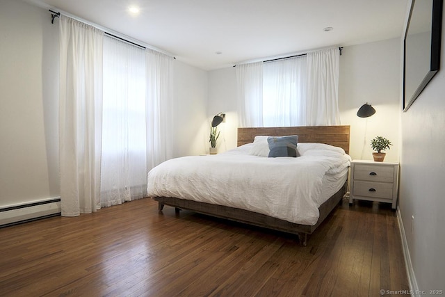 bedroom featuring baseboards and dark wood-type flooring