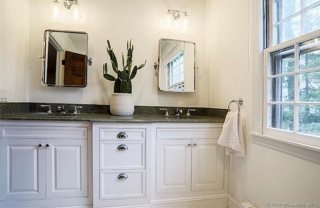 bathroom featuring a sink and double vanity