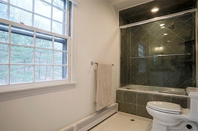 bathroom with tile patterned flooring, tiled shower / bath, and toilet
