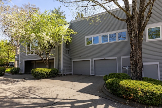 view of property featuring an attached garage and driveway