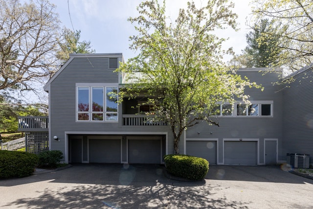view of front facade with a garage, driveway, and central AC