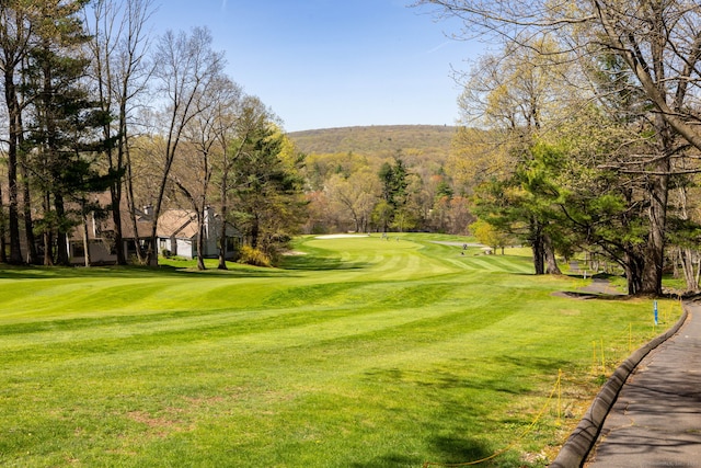 surrounding community with a lawn and golf course view