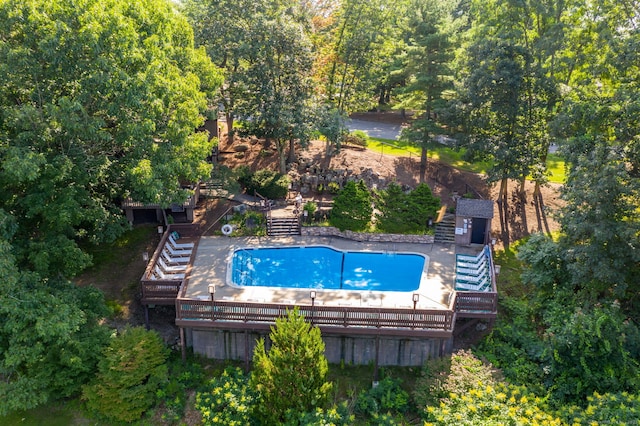 pool with stairway and a deck