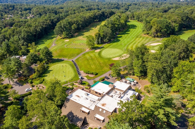 drone / aerial view with a view of trees and view of golf course