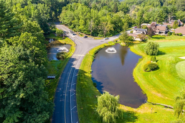 birds eye view of property with a water view and golf course view