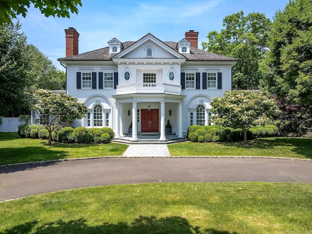 35 Club Rd, Greenwich, CT 06878 - neoclassical / greek revival house with a porch, a front yard, a balcony, and a chimney