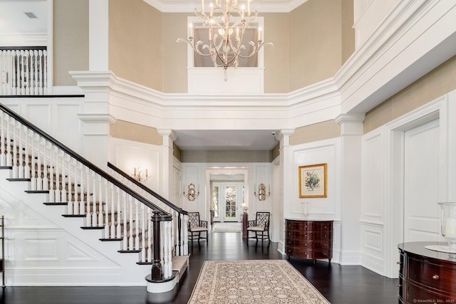 35 Club Rd, Greenwich, CT 06878 - foyer entrance featuring stairway, a chandelier, dark wood-style floors, a decorative wall, and a high ceiling