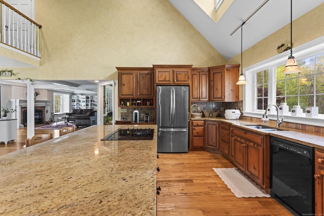 74 High St, Portland, CT 06480 - kitchen featuring light stone countertops, a sink, light wood finished floors, high vaulted ceiling, and black appliances