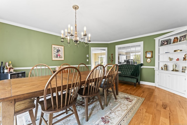 74 High St, Portland, CT 06480 - dining area featuring baseboards, a notable chandelier, ornamental molding, and wood finished floors