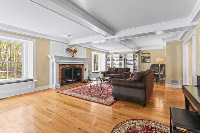 74 High St, Portland, CT 06480 - living area featuring visible vents, ornamental molding, a brick fireplace, wood finished floors, and beamed ceiling