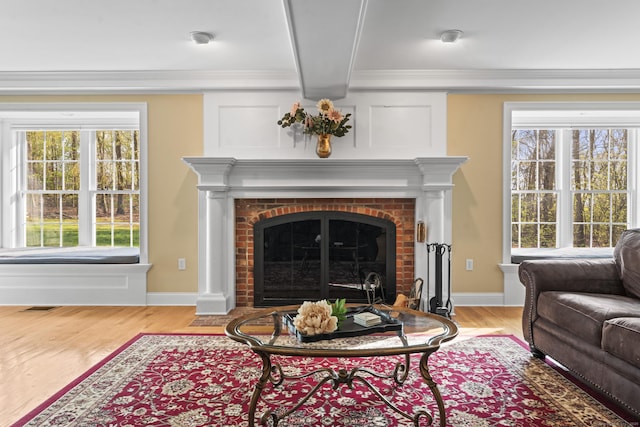 74 High St, Portland, CT 06480 - living room featuring crown molding, light wood finished floors, baseboards, and a fireplace