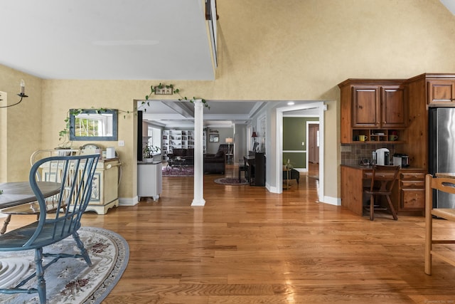 74 High St, Portland, CT 06480 - dining space featuring baseboards, light wood-style flooring, and a towering ceiling